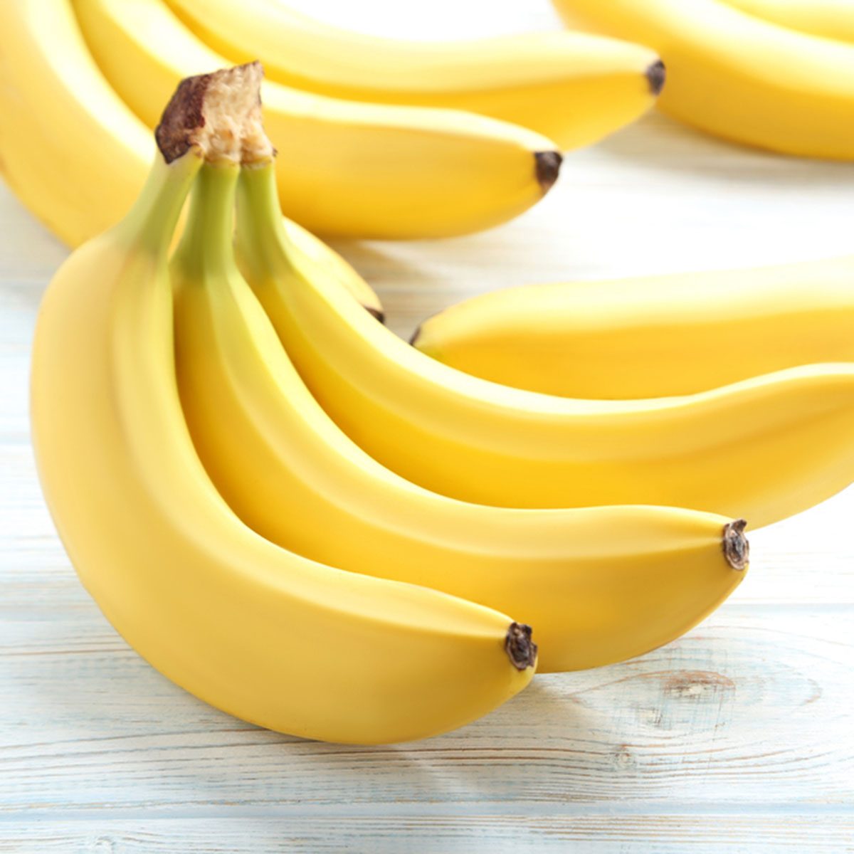 Sweet bananas on white wooden table; Shutterstock ID 626207750; Job (TFH, TOH, RD, BNB, CWM, CM): Taste of Home