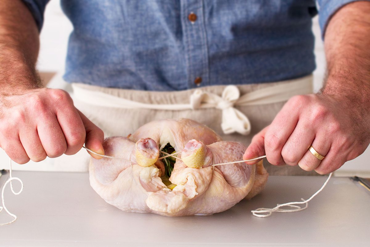 Trussing a chicken.