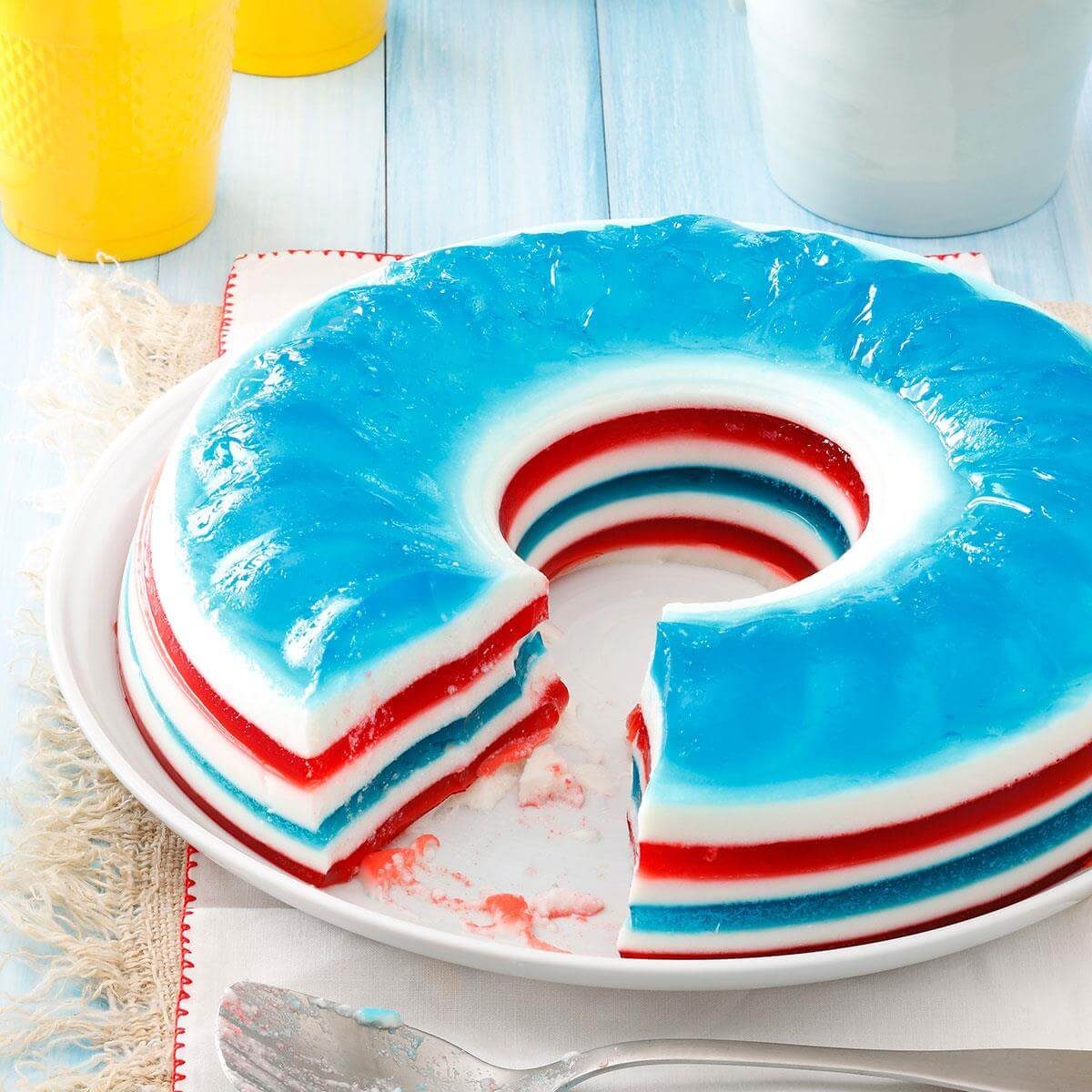 A plate with a molded red, white and blue layered gelatin salad.
