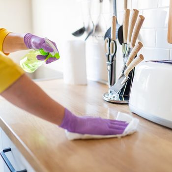 woman wiping counter top