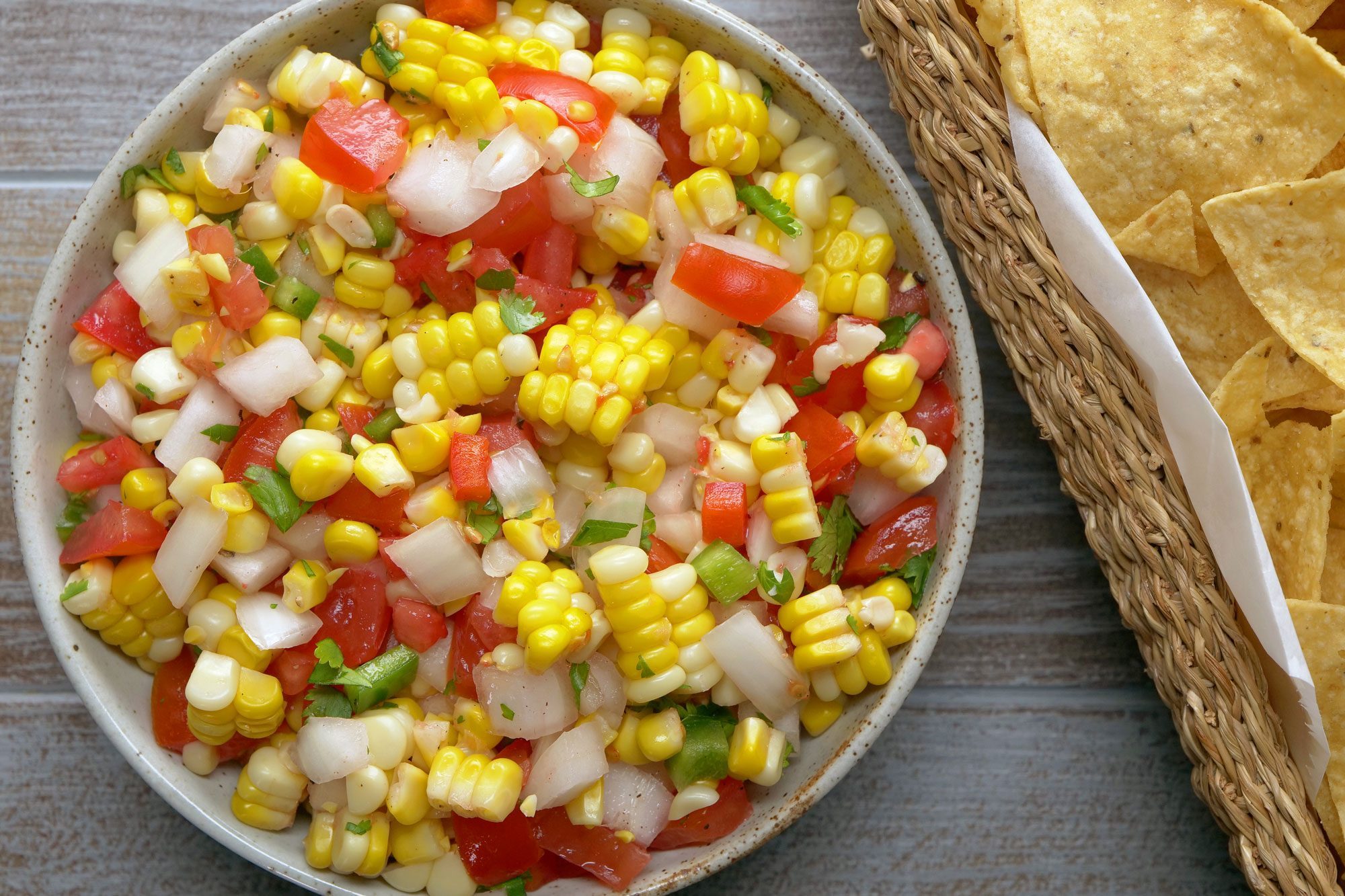 Corn Salsa in a large bowl served with nachos
