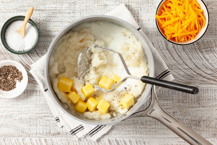 Mashing potatoes with cheese