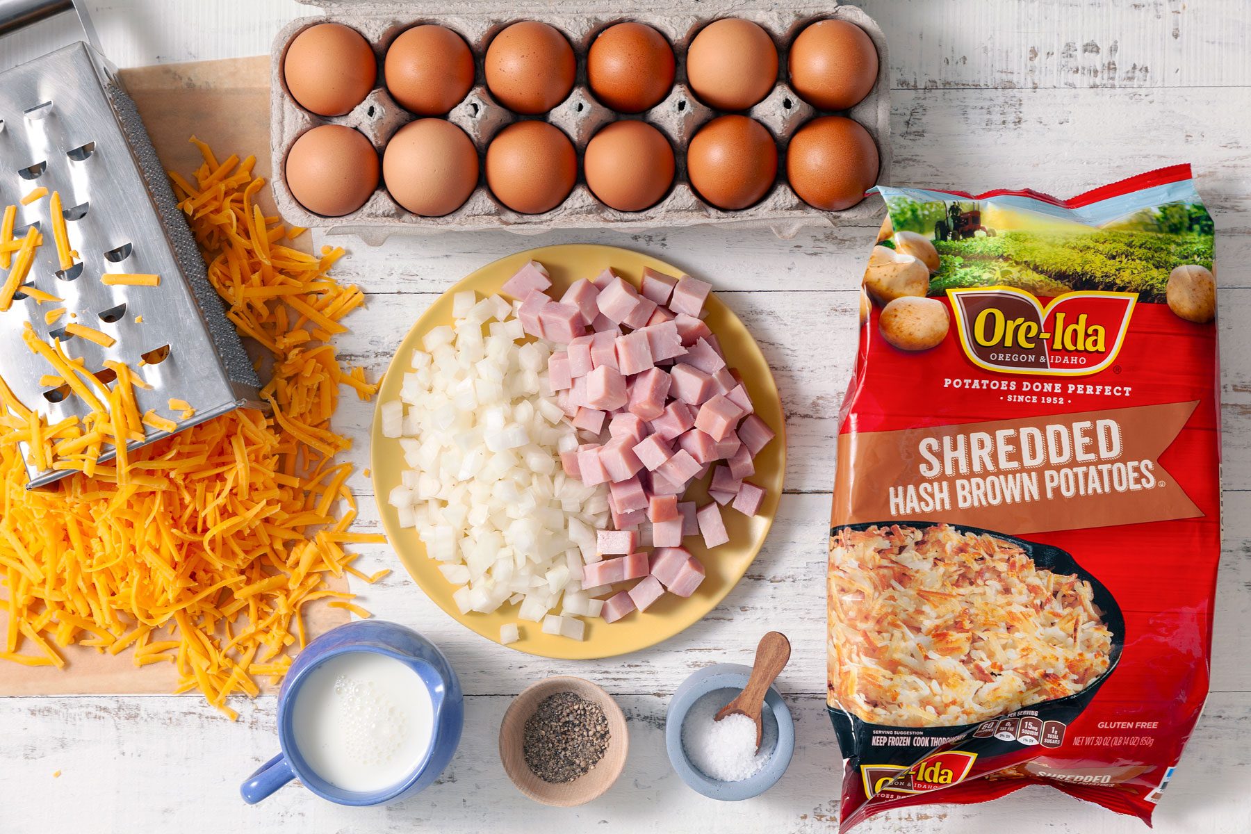 Eggs ham cheese and other ingredients on a table