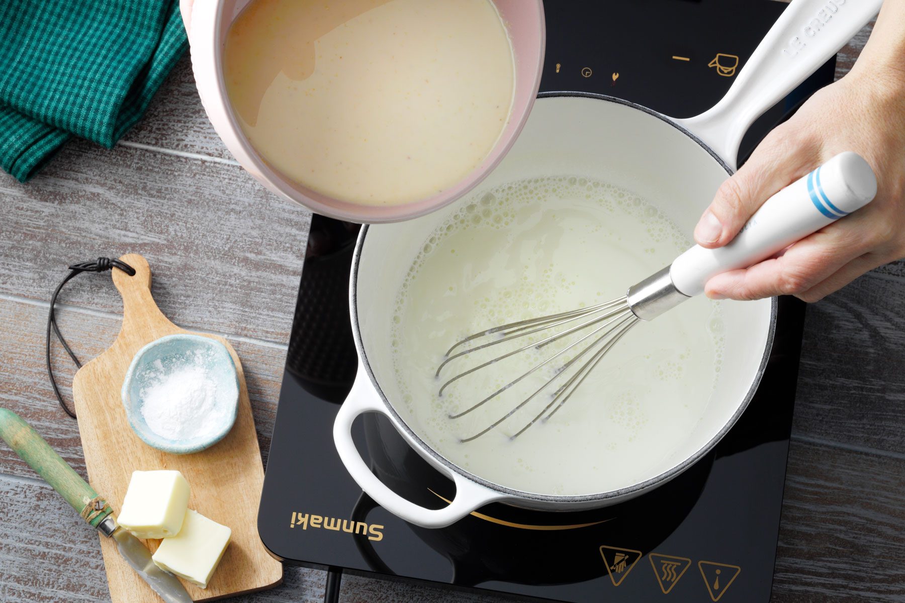 Mixture of cornmeal, sugar, salt poured in milf