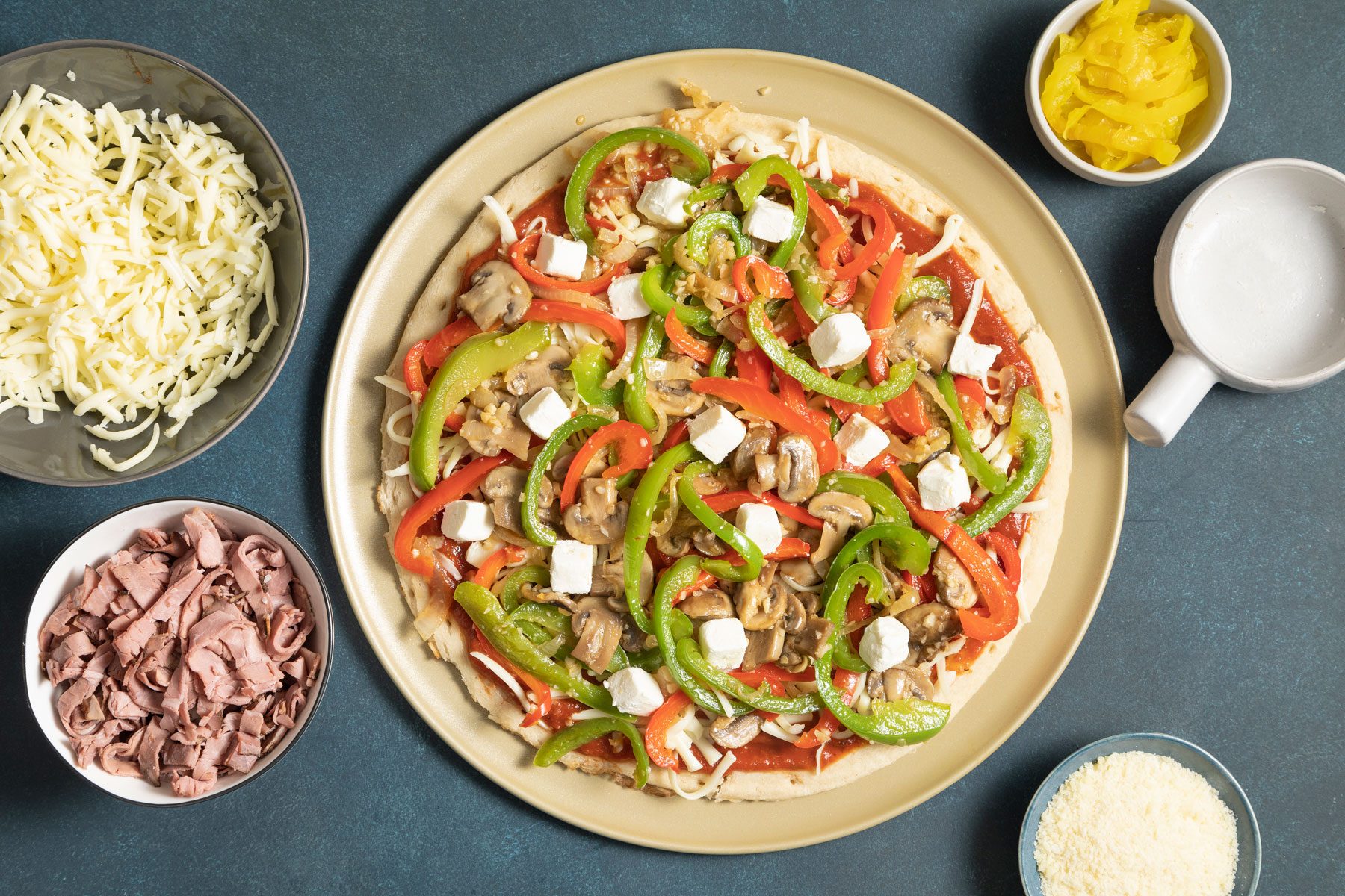 pepper mixture cheese and other ingredients on the pizza crust