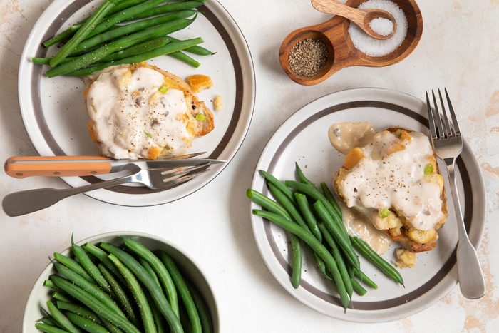 Two Plates of Pork Chops With Green Beans