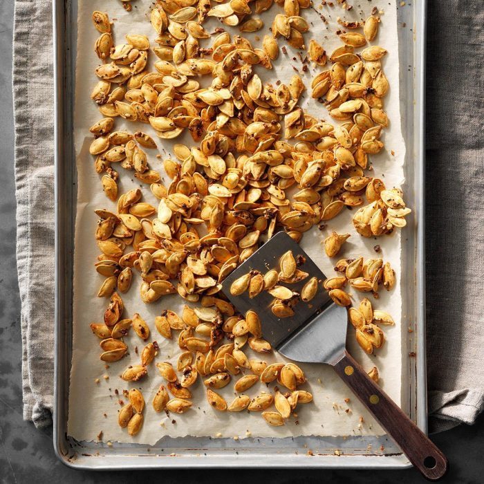 garlic pumpkin seeds on a baking sheet