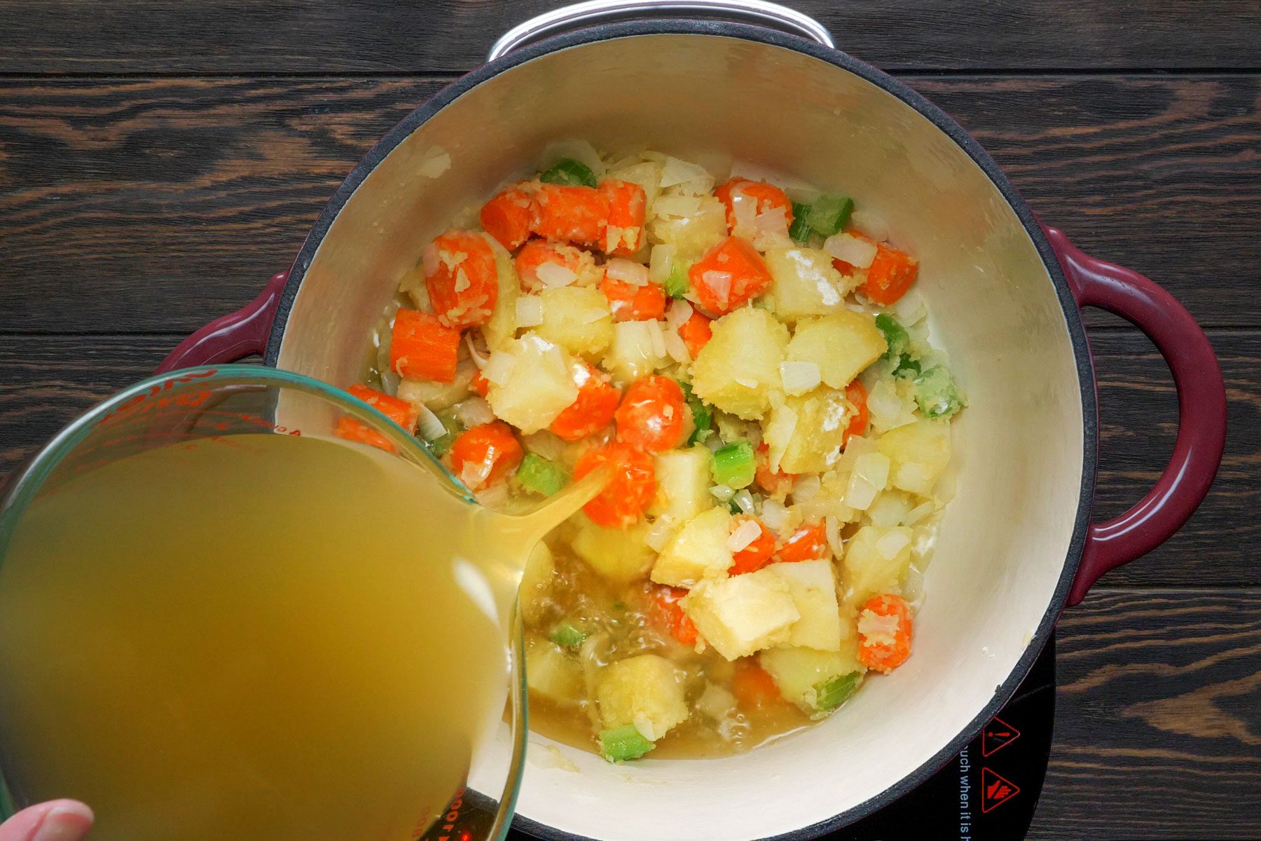 Broth is added to the vegetables in a pot Turkey Potpies