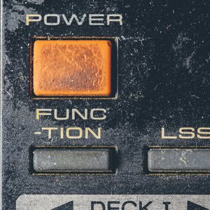 Rubber buttons on an old retro electronic remote control; dusty; old; remote