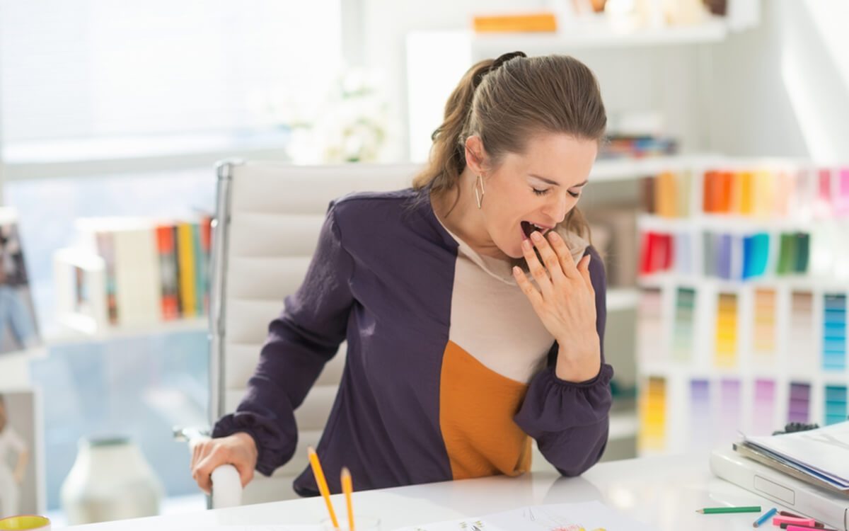 Fashion designer in office yawing