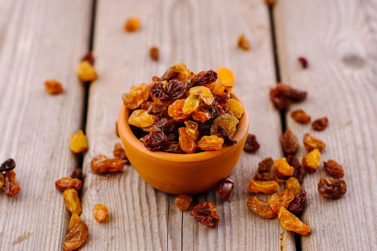 bowl of raisins. raisins on a wooden background