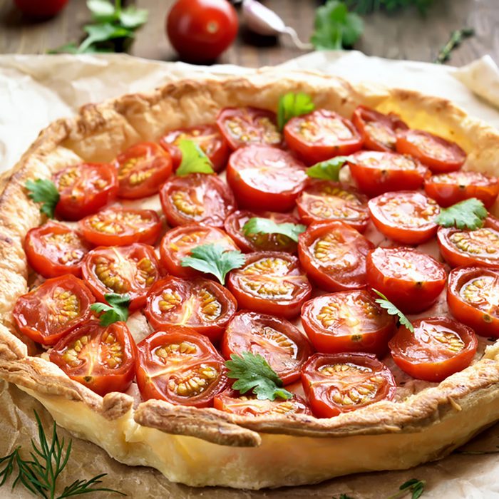 Tomato pie on baking paper, close up view