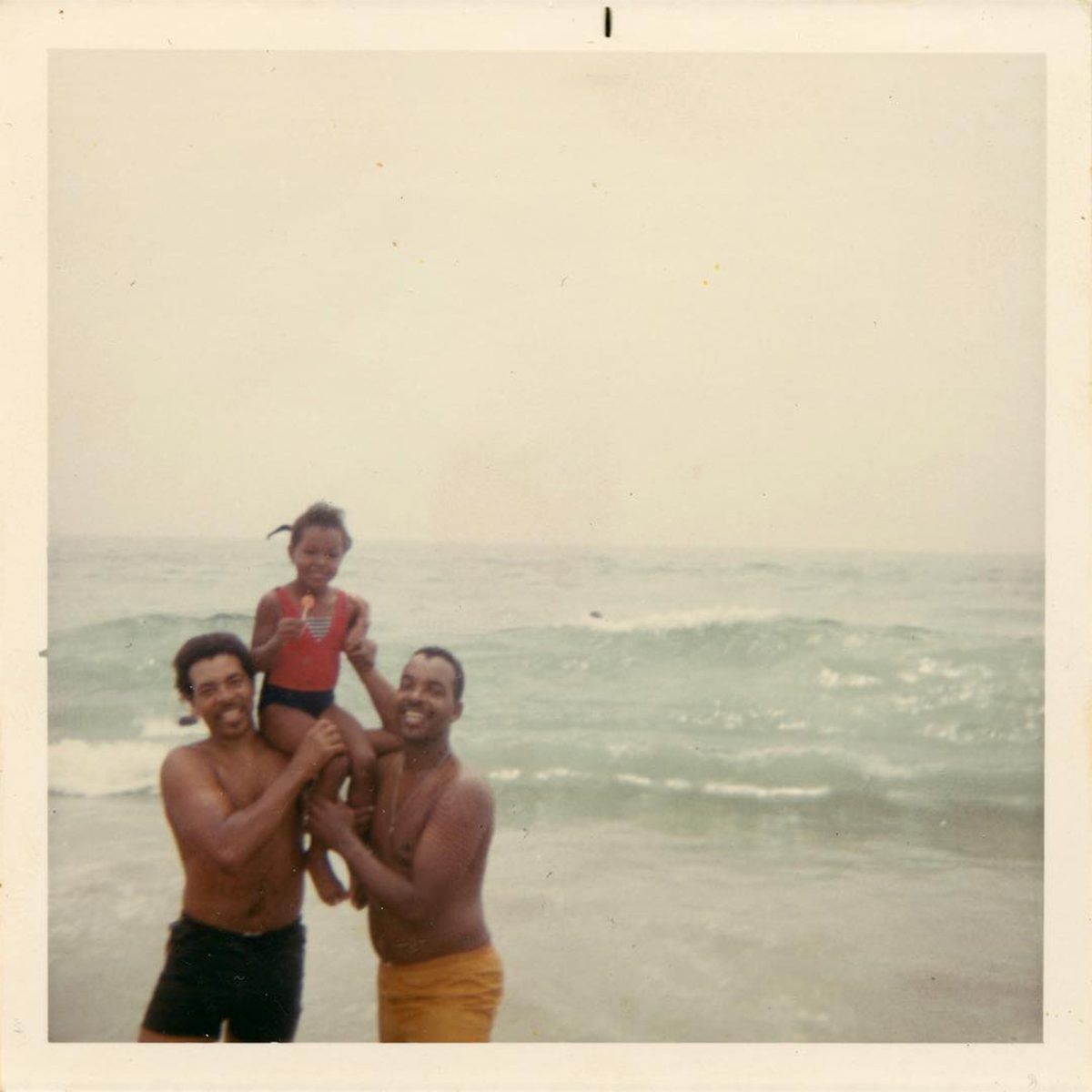 family playing at the beach vintage
