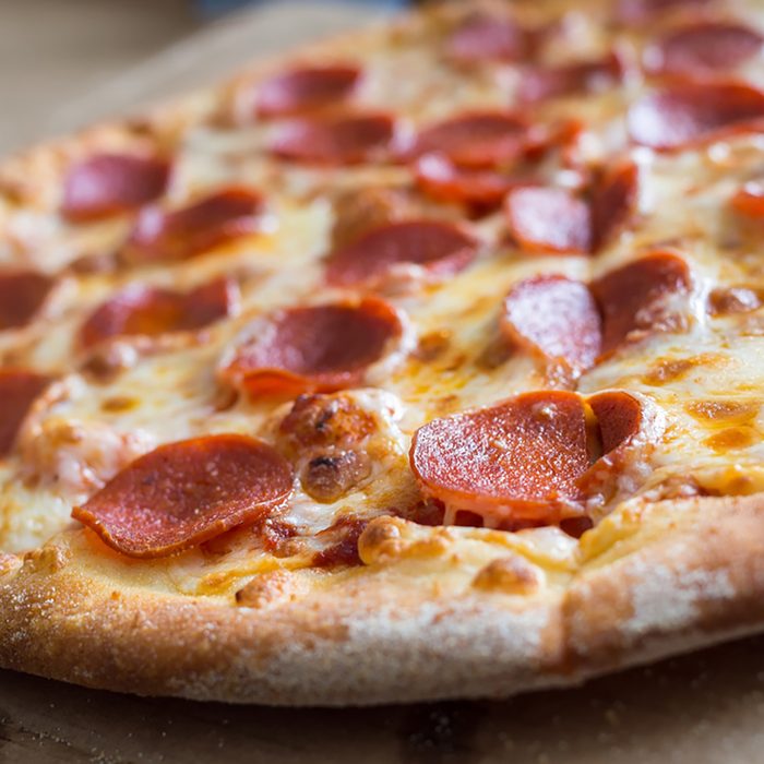 Fresh baked pepperoni pizza, shallow depth of field; Shutterstock ID 522293875