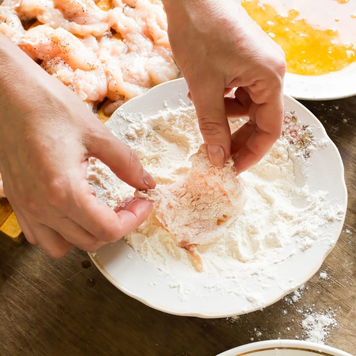 Raw chicken fillet in flour;