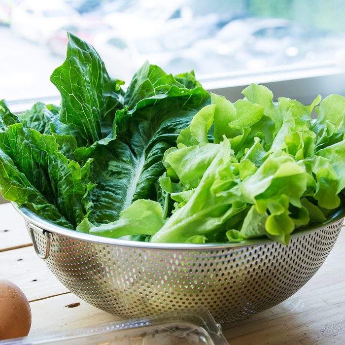 Green leafy vegetables with eggs on wooden background