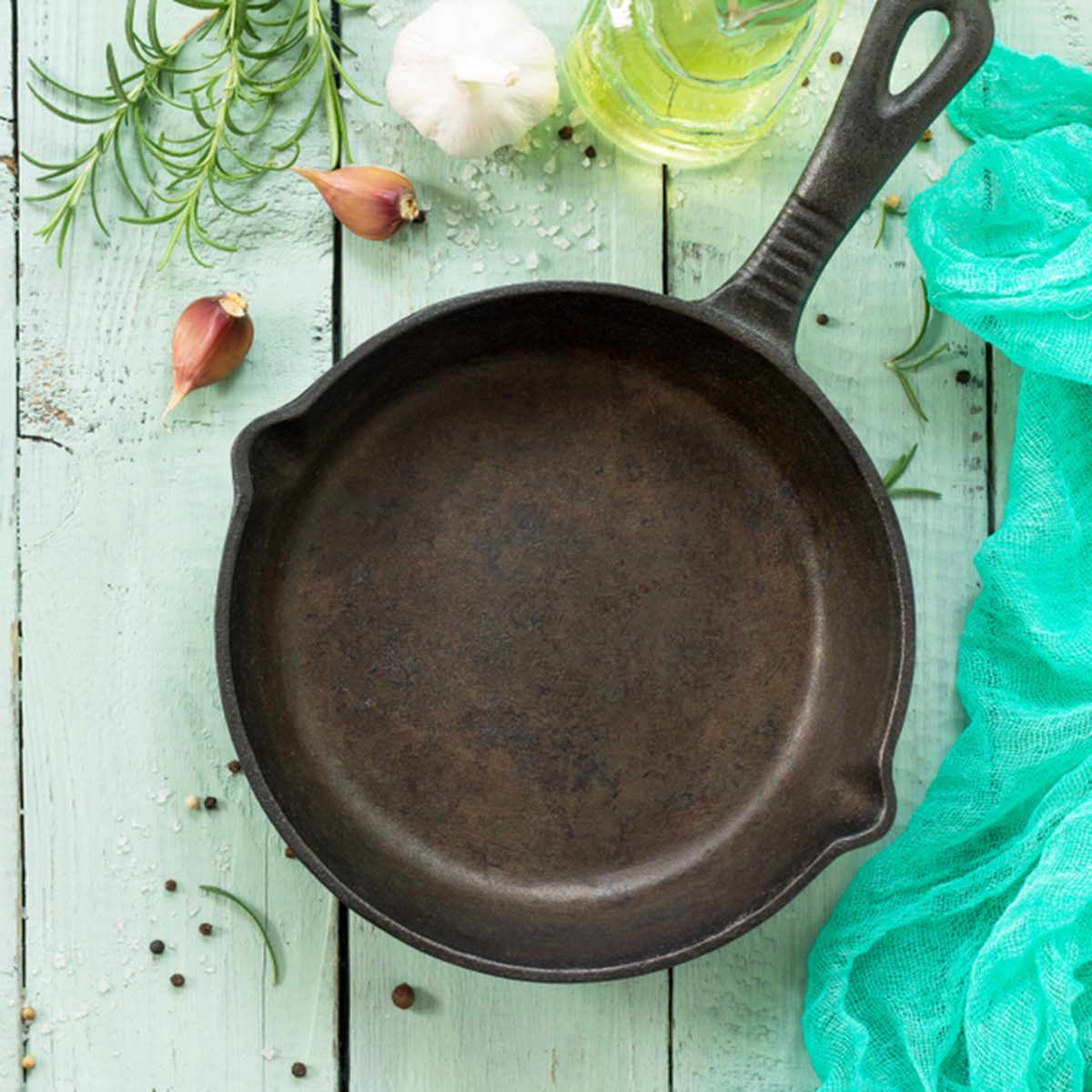 Cast-iron frying pan, fresh rosemary, garlic, olive oil and spices.
