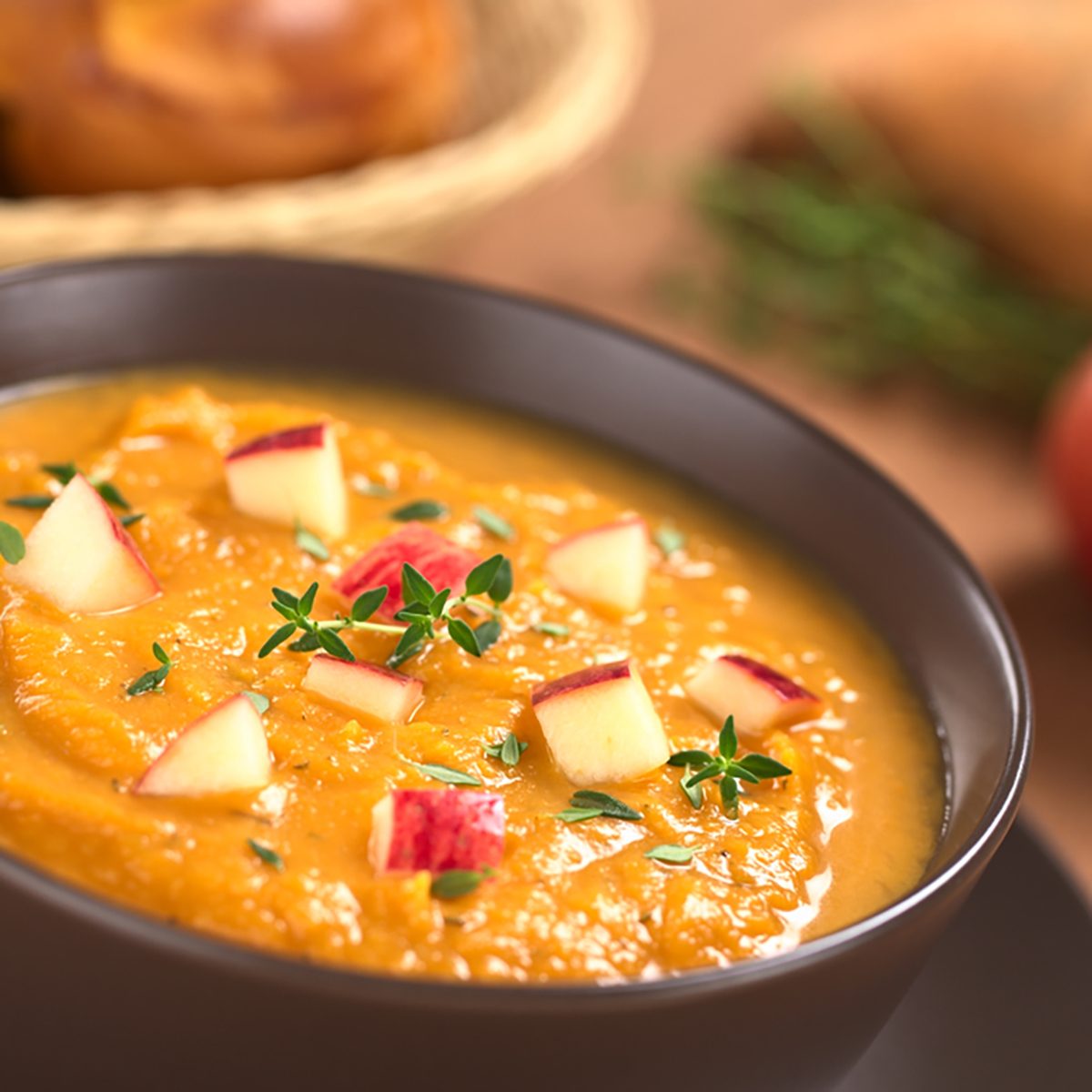Bowl of fresh homemade sweet potato and apple soup with thyme