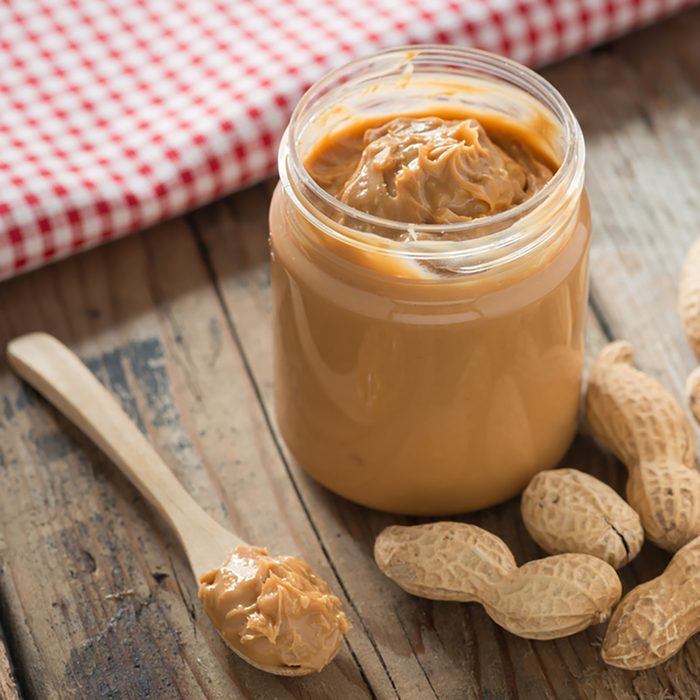 Creamy peanut butter on wood table