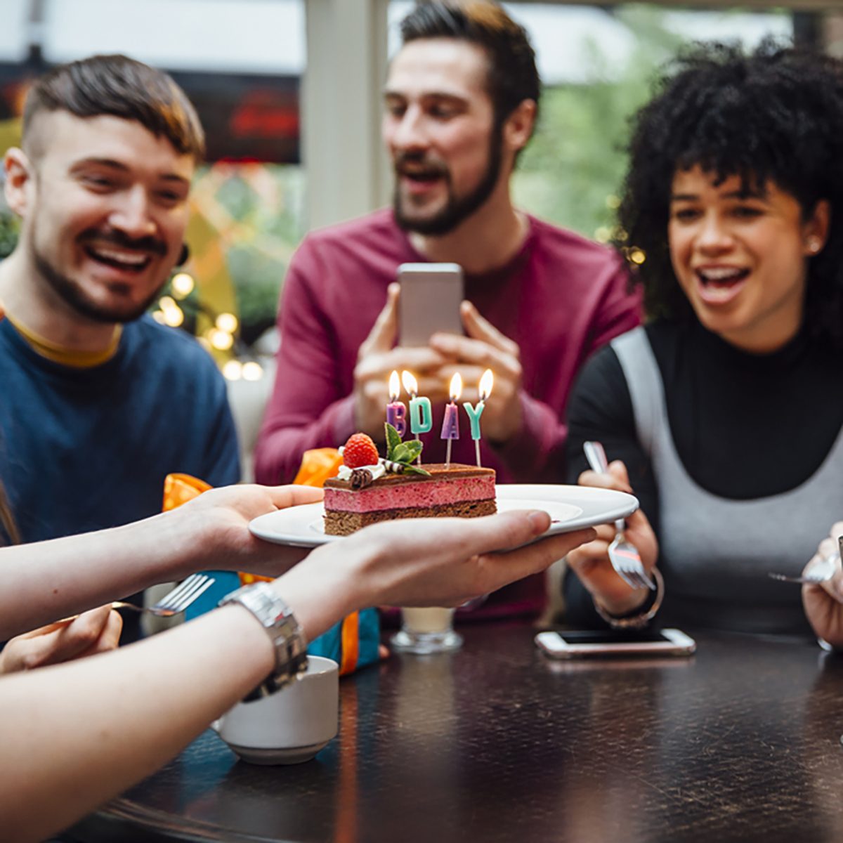Group of friends are in a bar celebrating on of the women