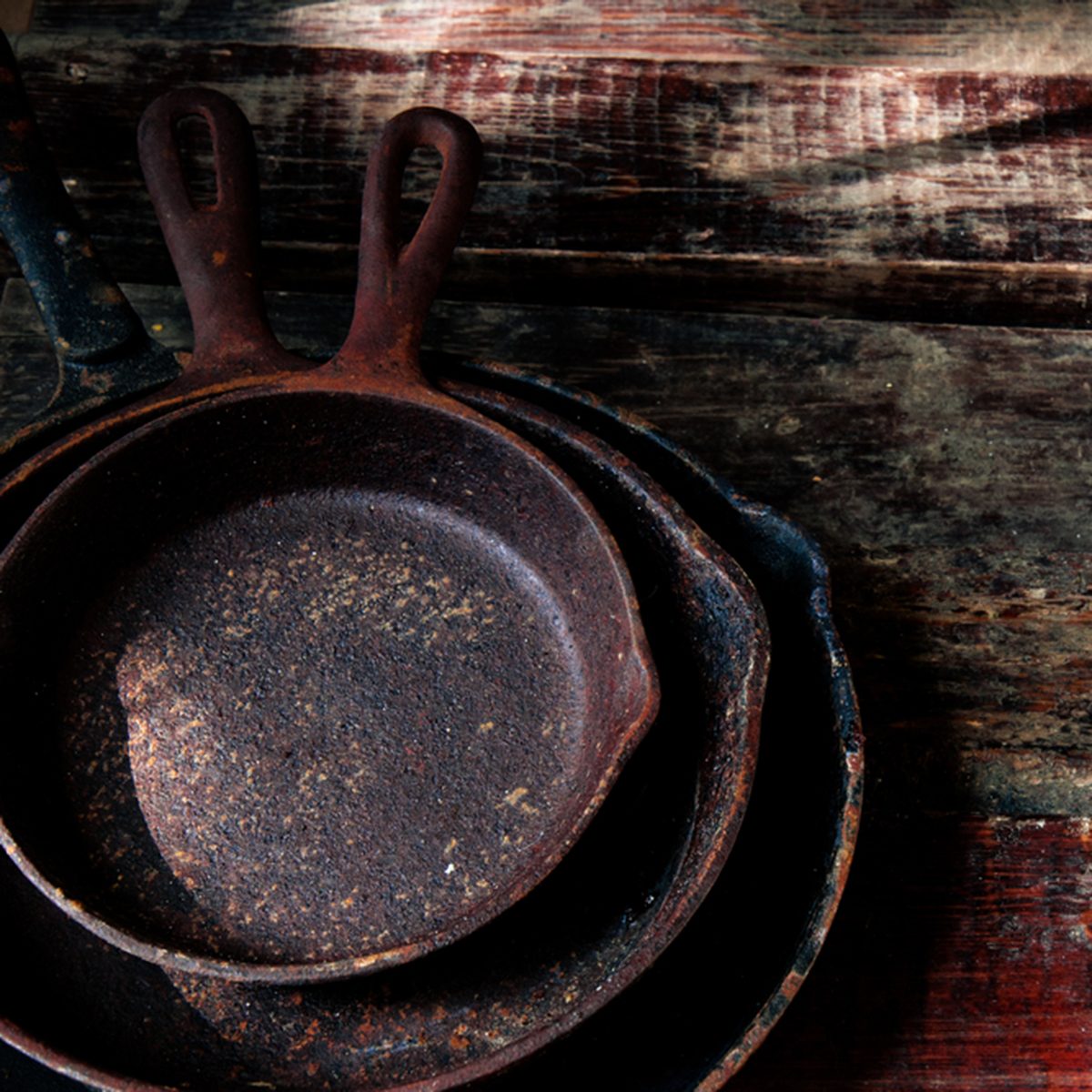 a stack of three cast iron skillets