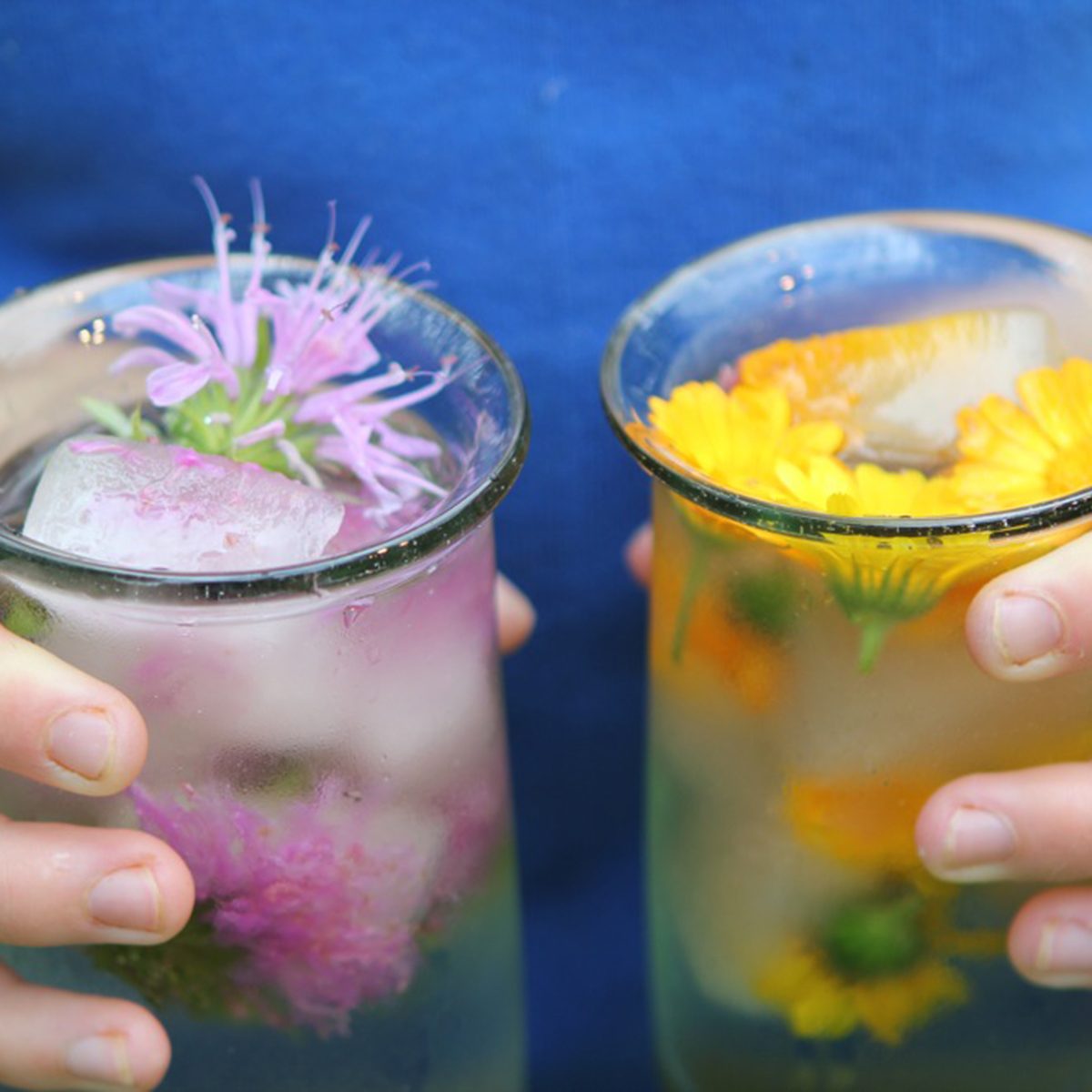 Woman holding a drink in each hand