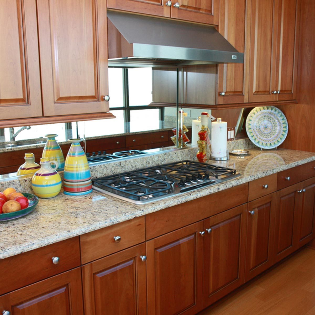 Kitchen with wooden cabinets and a mirror backsplash
