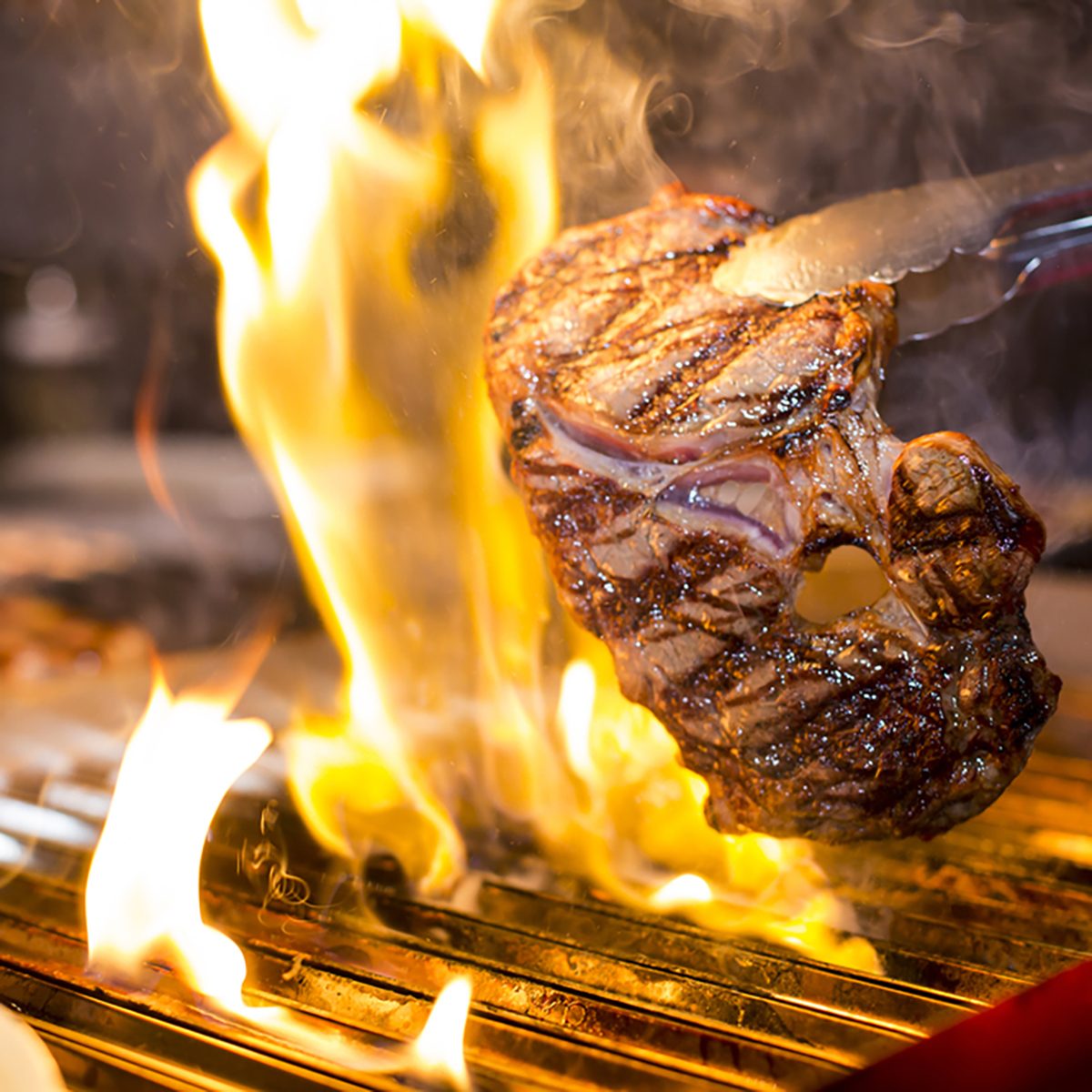 Steak on the grill with flames