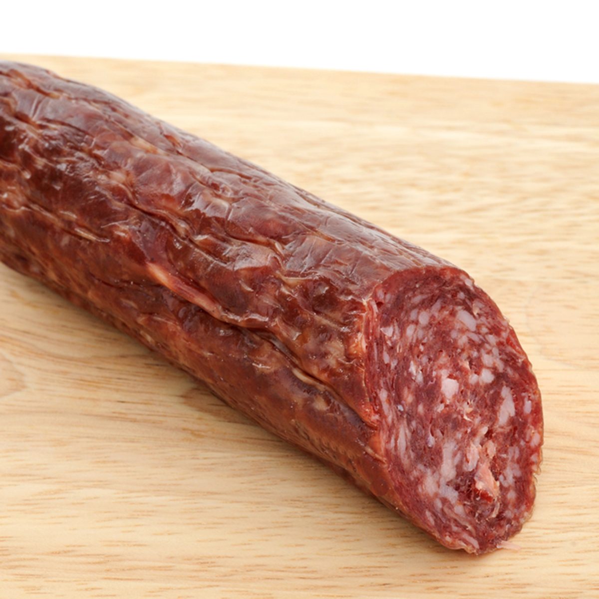 Fresh reindeer-salami on a brown cutting board