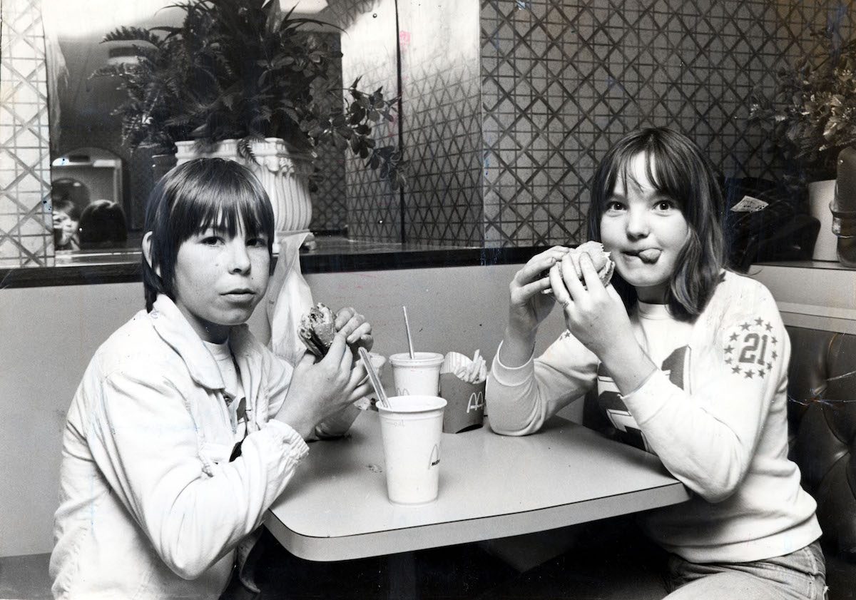  Two children eating hamburgers in McDonalds 