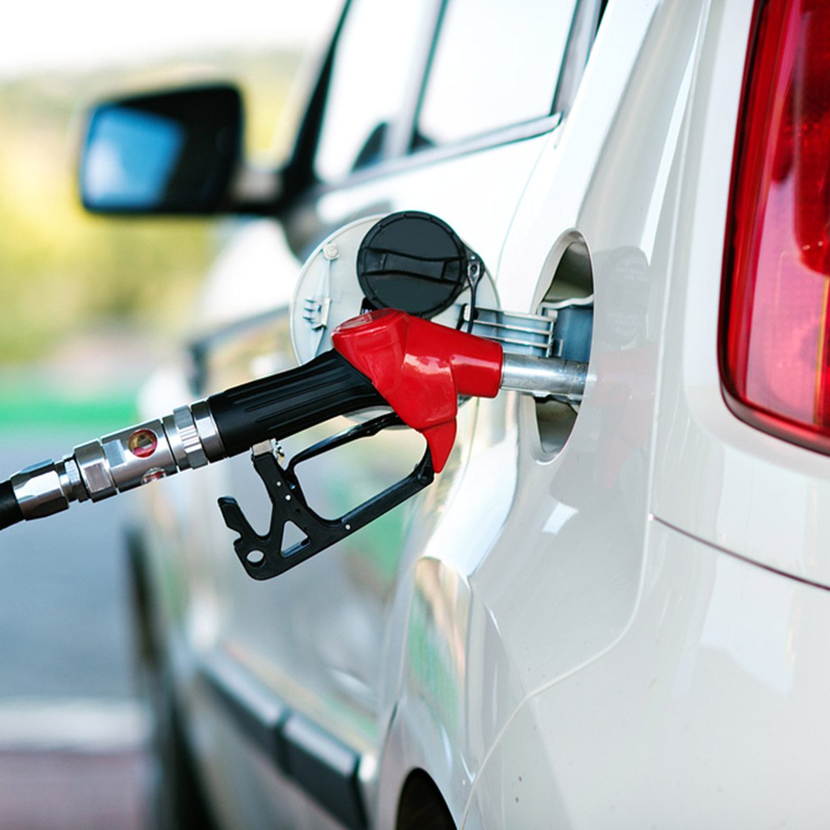 To fill the machine with fuel. Mashunya fill with gasoline at a gas station. Gas station pump. Man filling gasoline fuel in car holding nozzle. Close up.; Shutterstock ID 148217705