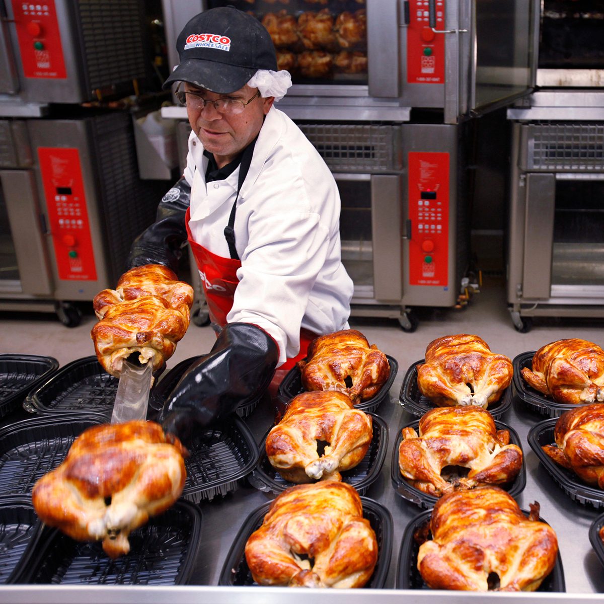 A Costco employee cooks chicken at Costco in Mountain View, Calif.