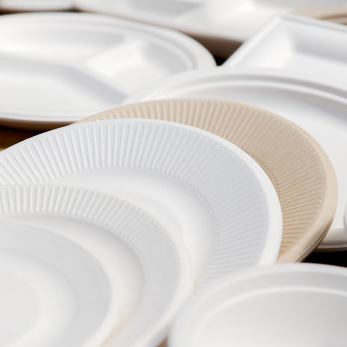 a variety of paper disposable plates of different colors