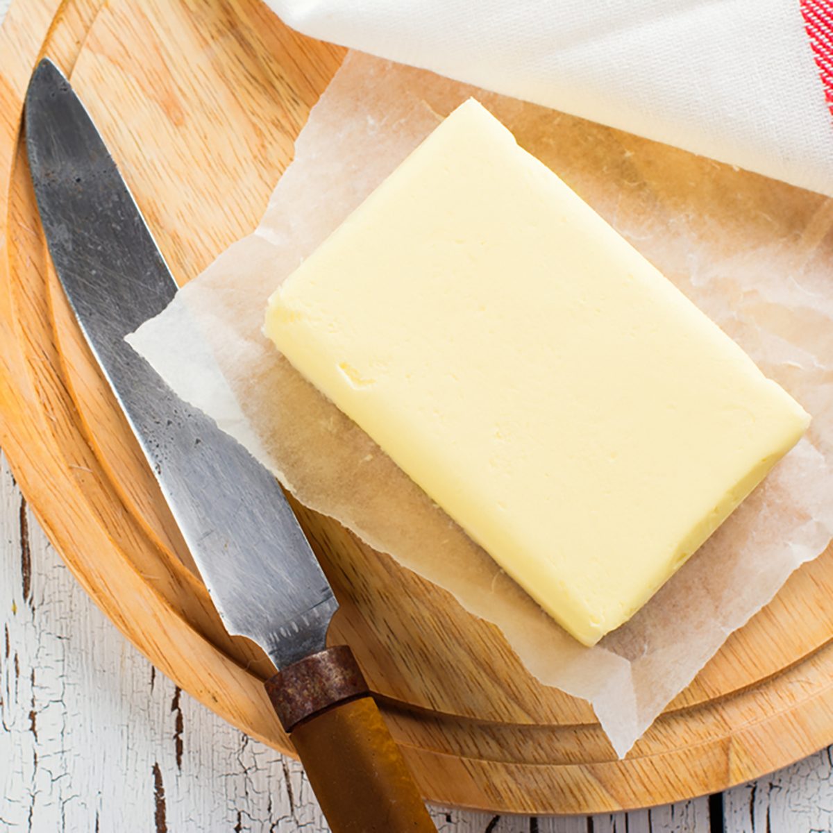 Butter stick on wooden board. Baking or cooking concept