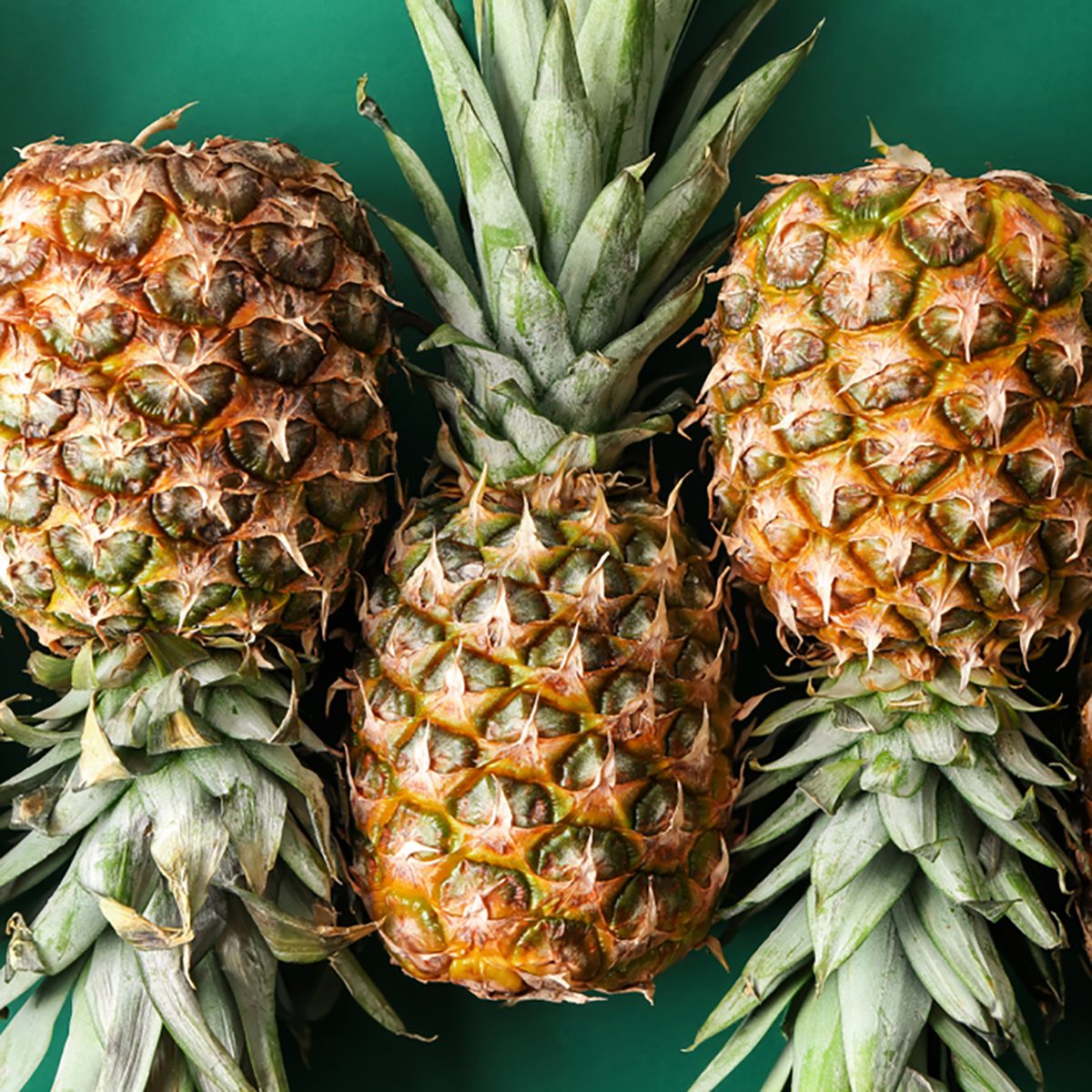 Ripe pineapples on color background