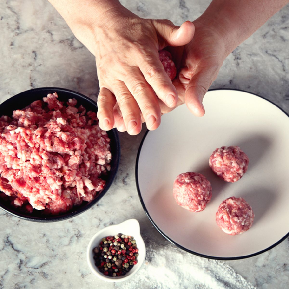 Hands making meatballs