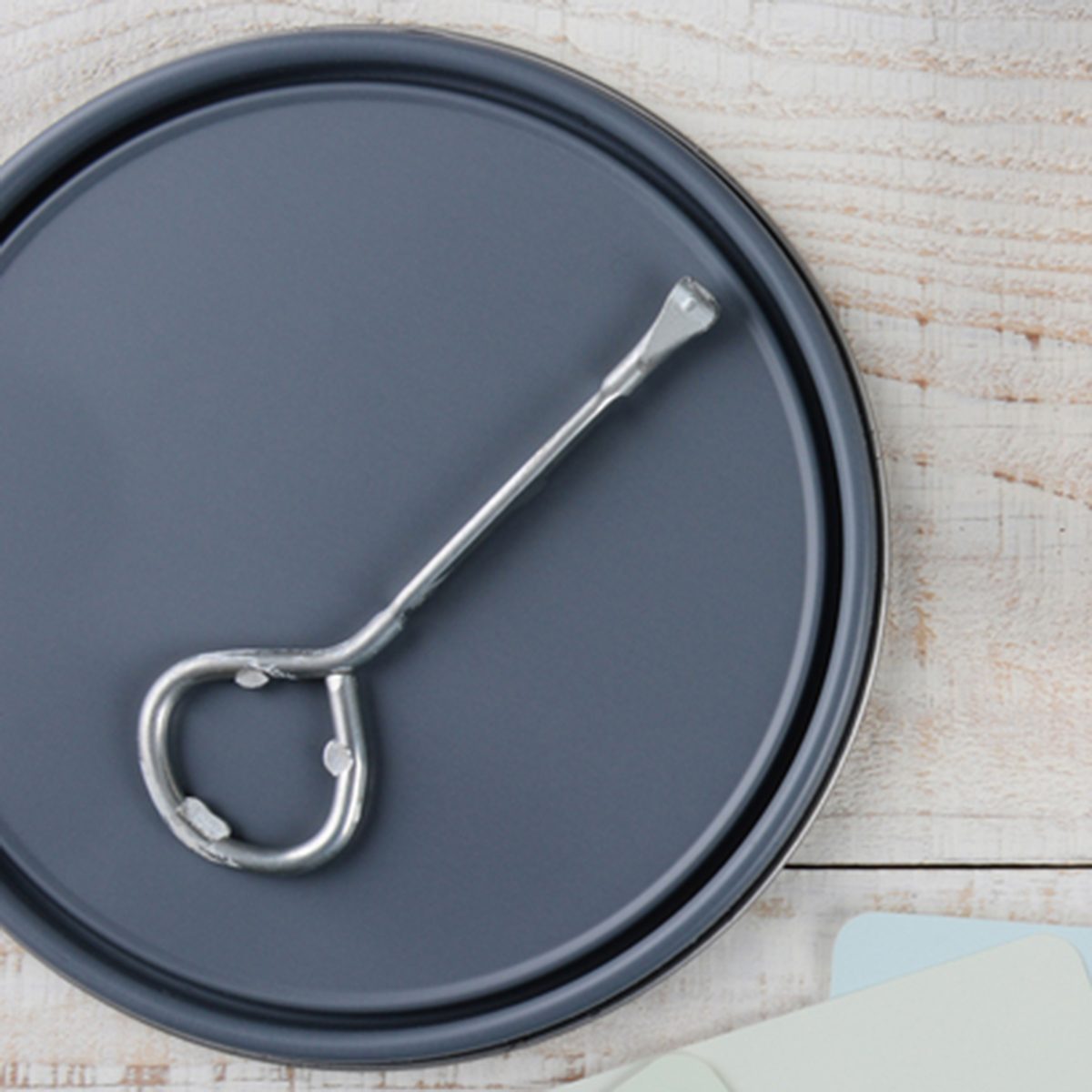 Overhead shot of a paint can lid, opener, color samples and paint brush on a rustic wooden surface. Horizontal format with copy space. ; Shutterstock ID 242845189; Job (TFH, TOH, RD, BNB, CWM, CM): TOH