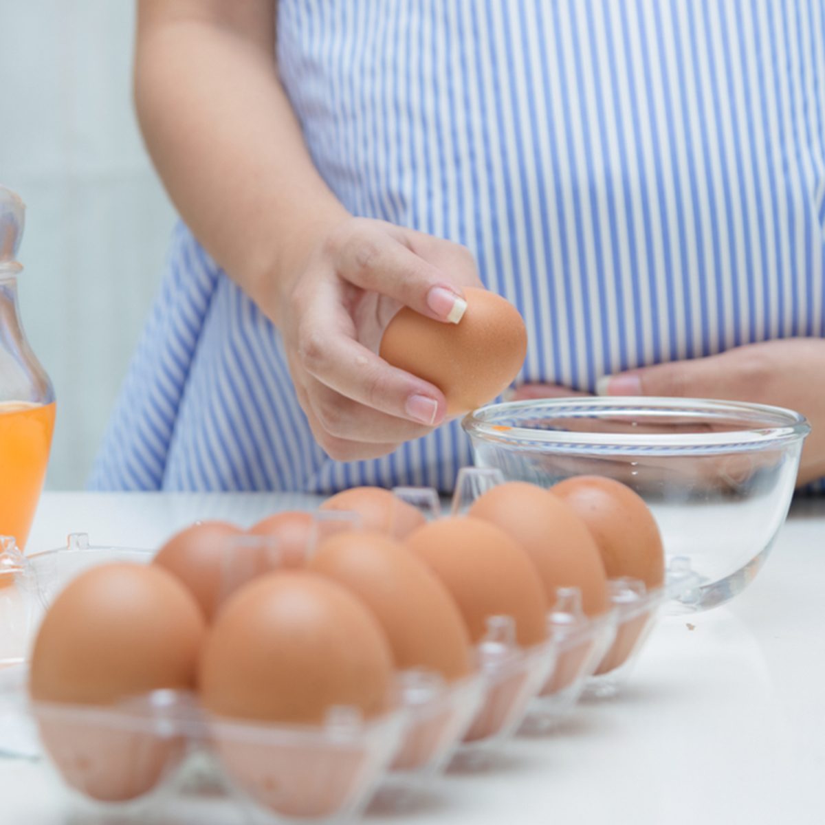 Pregnant woman preparing meal at table in the kitchen,healthy nutrition during pregnancy