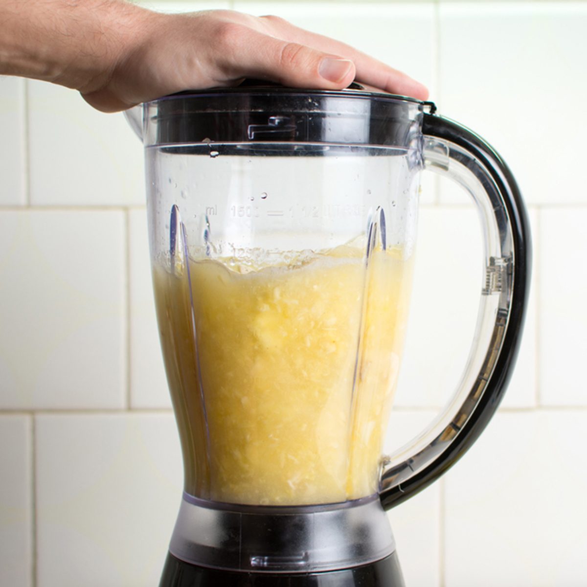 Using blender for making a healthy smoothie; Shutterstock ID 587714921