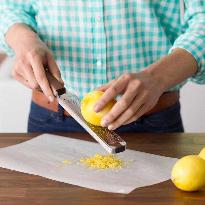 zesting a lemon with a microplane