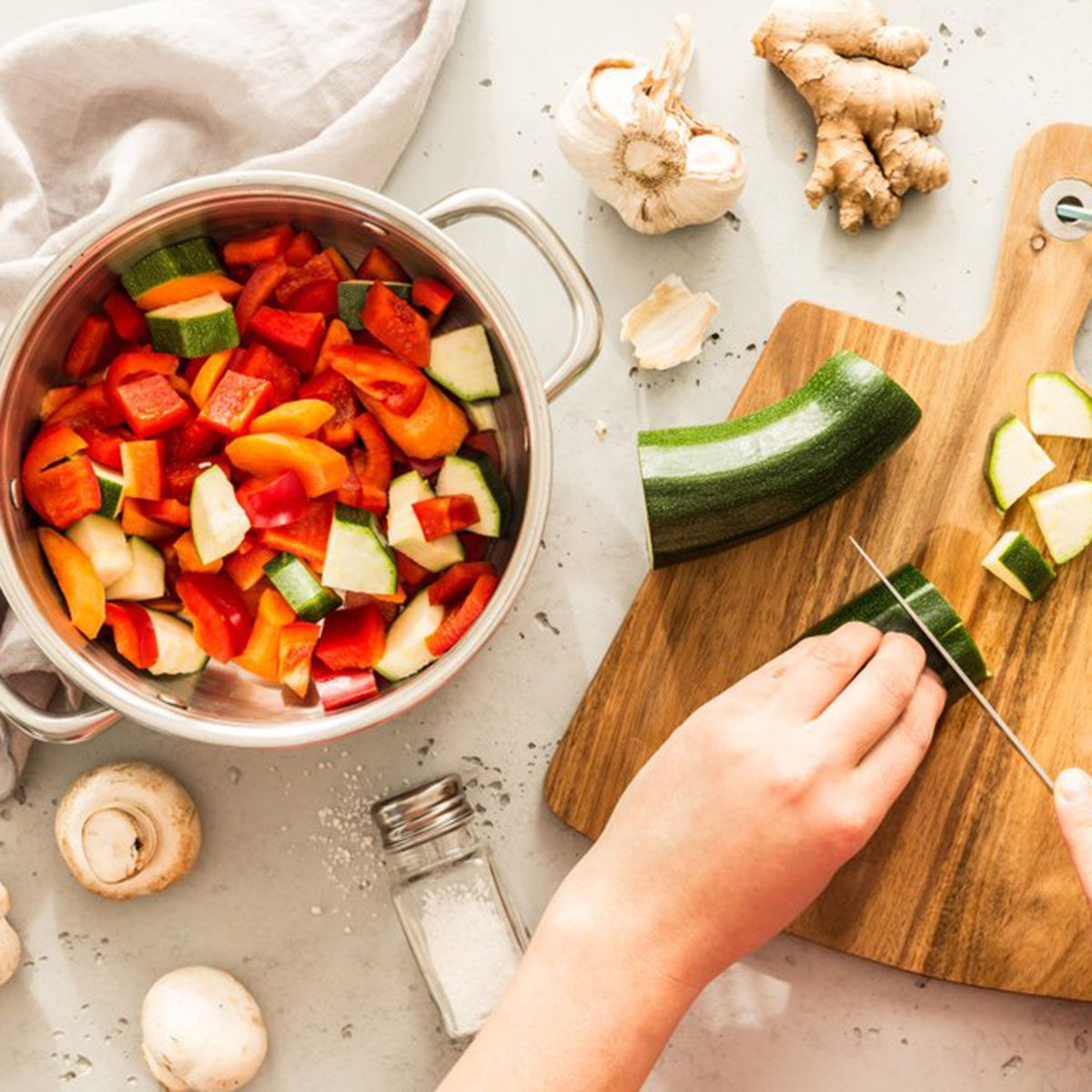 Chopping veggies and putting them into a pot