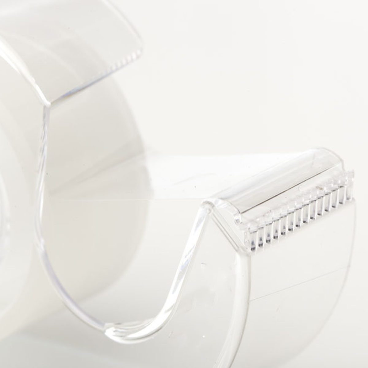 A Clear tape dispenser against a white background