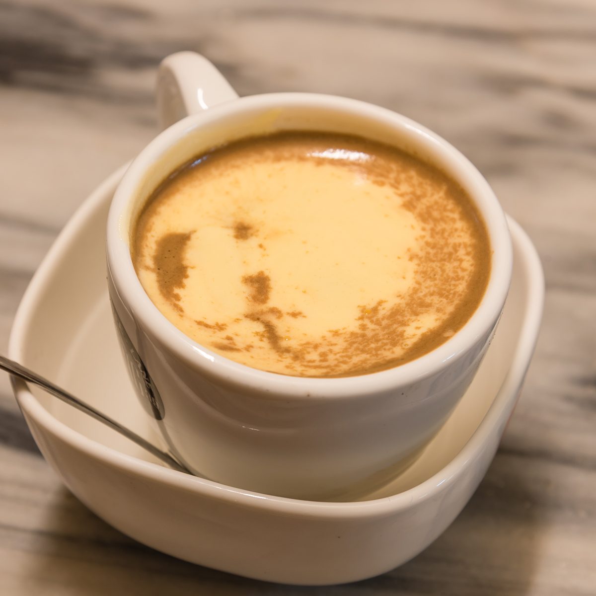 Top view a cup of Giang egg coffee in Hanoi on marble table.