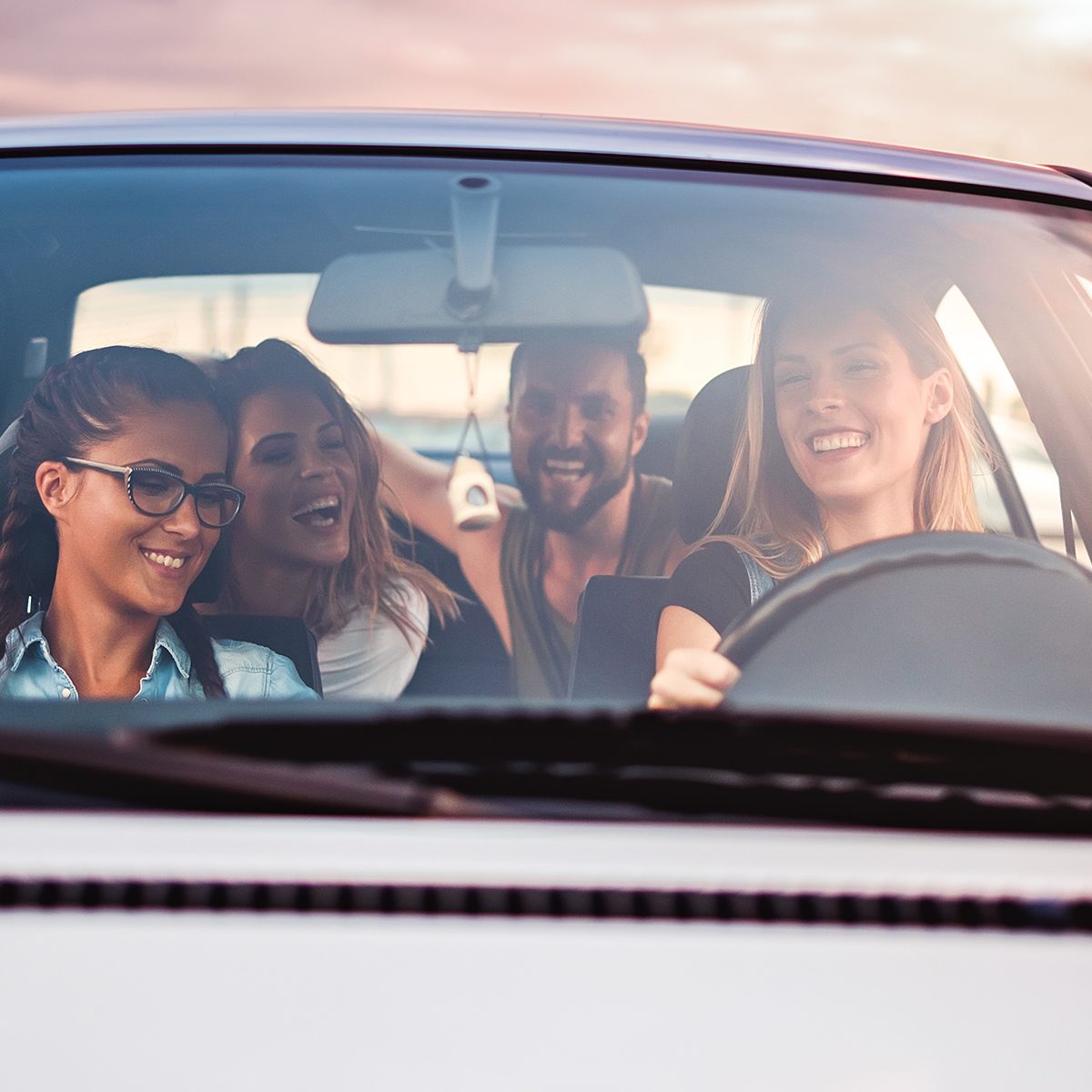 Group of friends having fun in the car. 