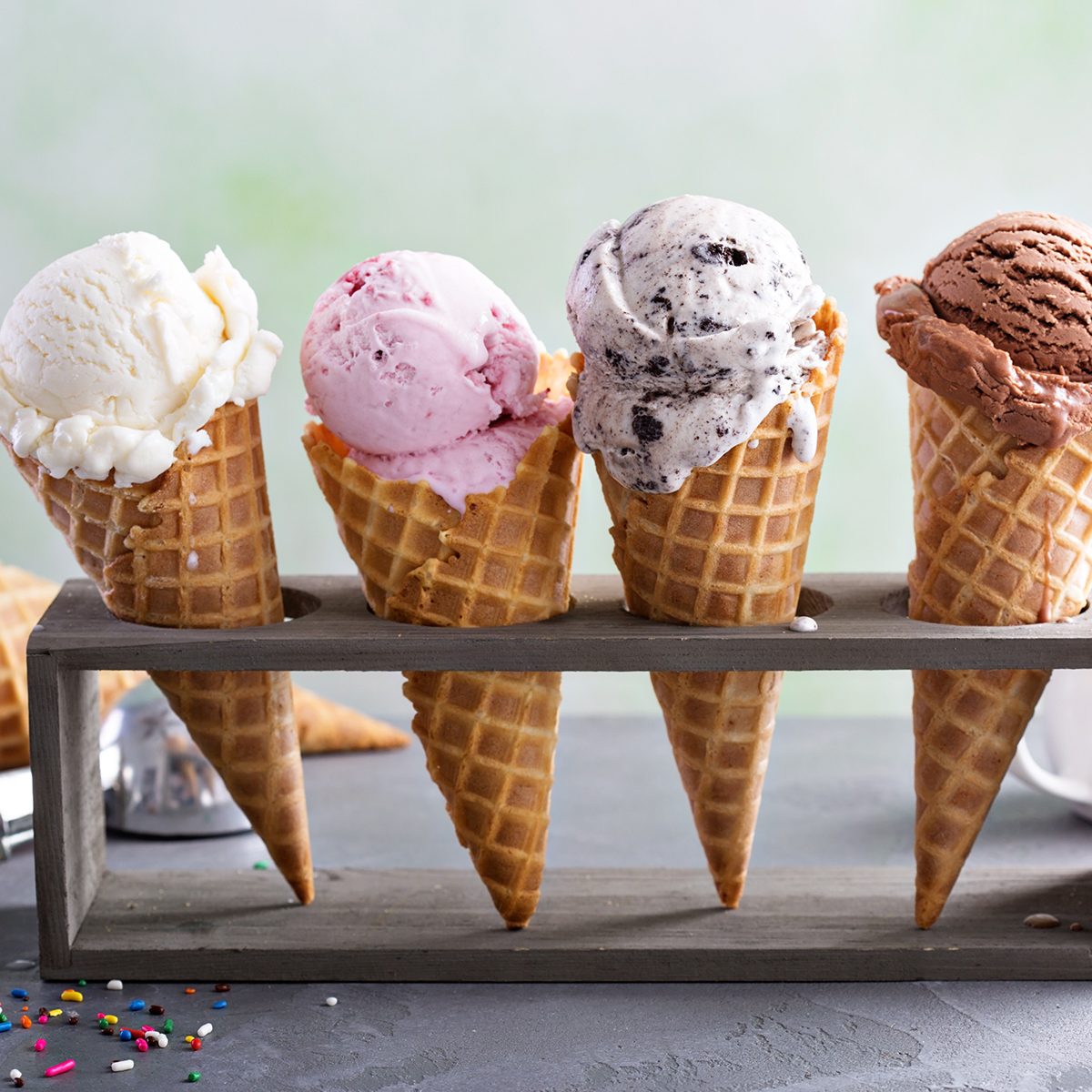 Variety of ice cream scoops in cones with chocolate, vanilla and strawberry