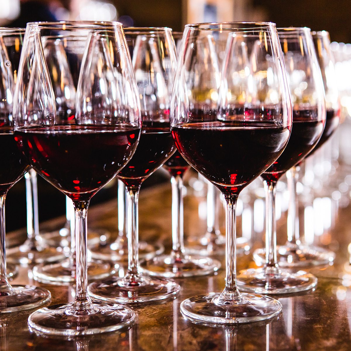 Glasses with red wine on blurred background