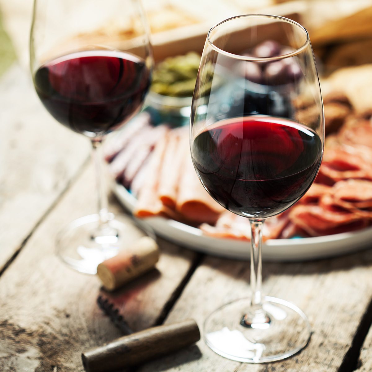 Red wine with charcuterie assortment on the background