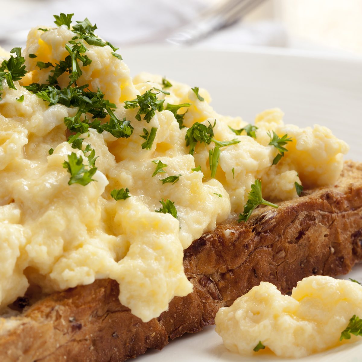 Scrambled eggs on toasted wholegrain bread.