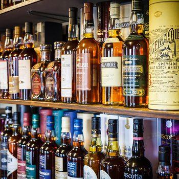 Various bottles of Scotch whisky on the shelf on May 16, 2015 in Tomintoul, UK.