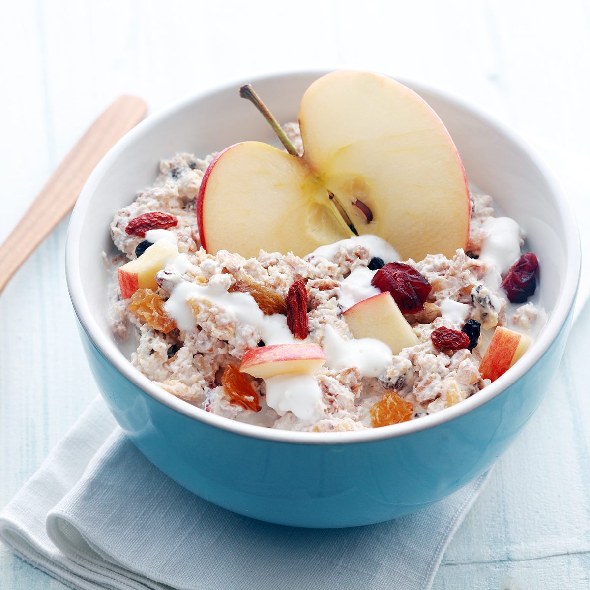 Healthy bowl of muesli, apple, fruit, nuts and milk for a nutritious breakfast with a low glycemic index ensuring plenty of energy for the day